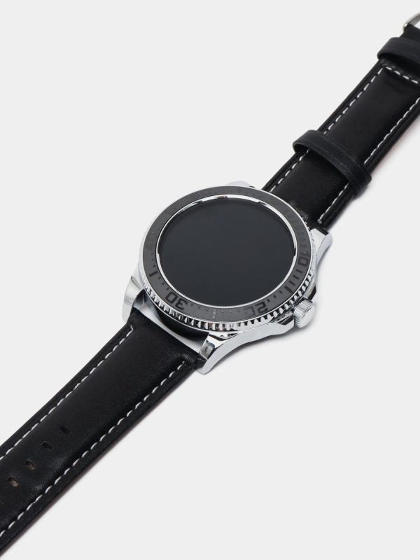 Watch with black leather strap and silver case on a light gray background