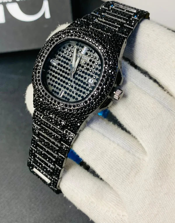 Black diamond-encrusted watch on a white surface