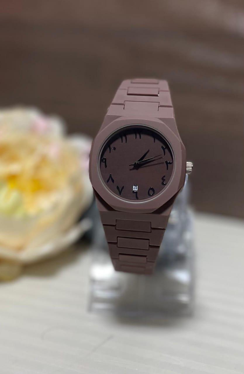 Brown watch on a clear stand with a blurred background