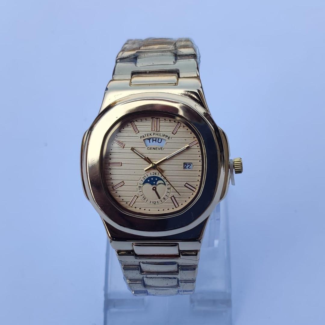 Silver watch with a detailed face on a light blue background